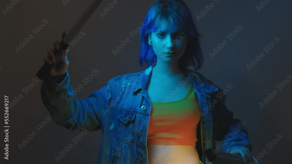 Young stylish woman in denim jacket posing with led stick lights on grey background, flowers lips face art, ukrainian colors style isolated lady Young stylish woman in denim jacket posing with led stick lights on grey background, flowers lips face art, ukrainian colors style isolated lady