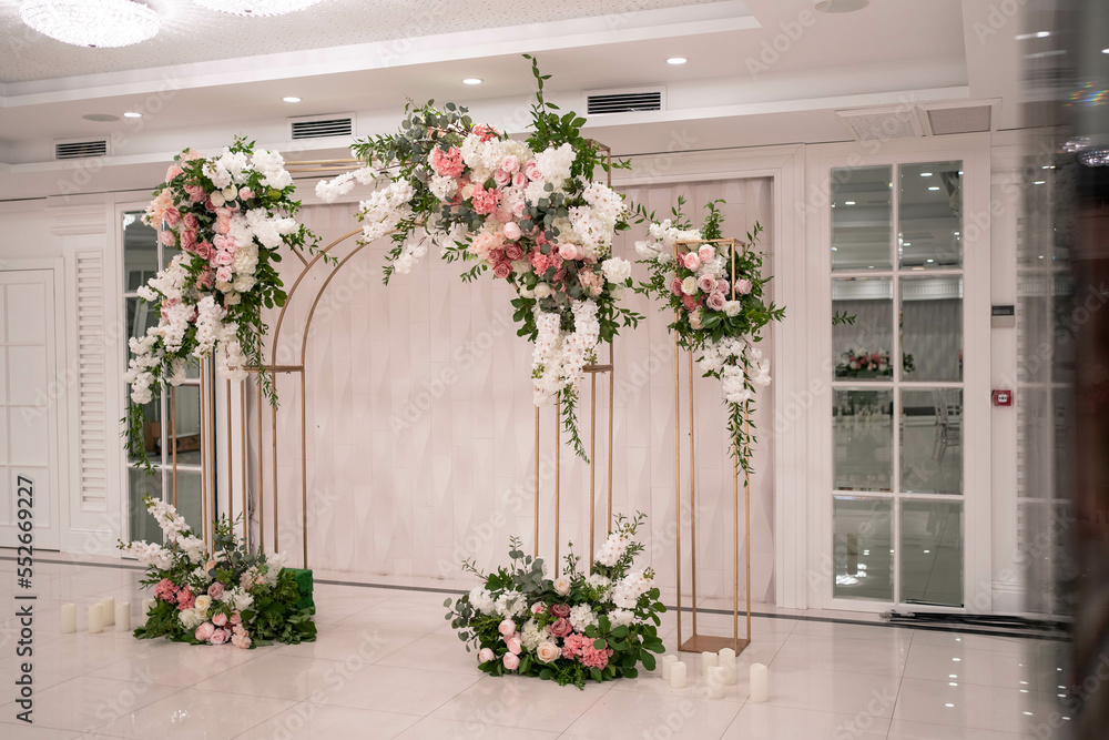 Arch for the wedding ceremony, decorated with white and pink flowers.