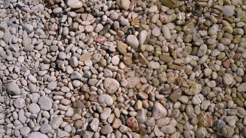 Sun shines to small gravel stones at Limni beach in Corfu, Greece - sea is crystal clear here Sun shines to small gravel stones at Limni beach in Corfu, Greece - sea is crystal clear here