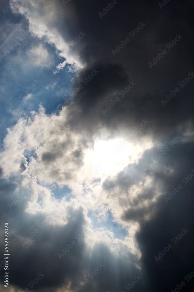 sun rays filtering through different cloud shapes