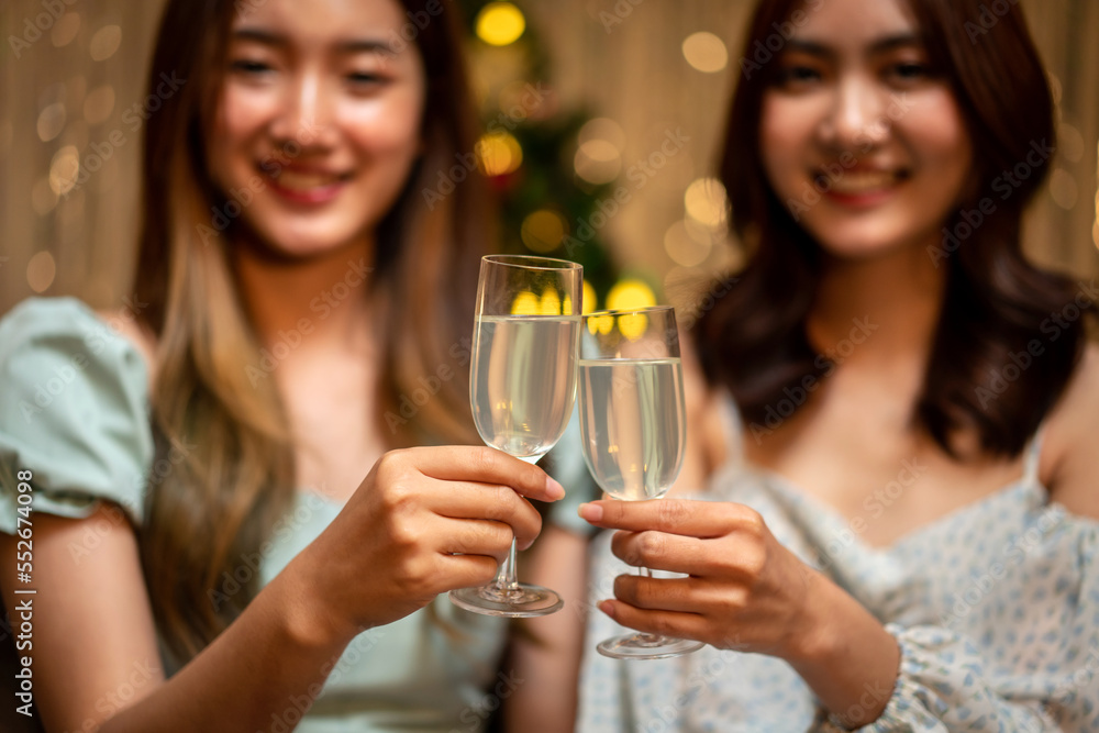Young beautiful people is sitting on the couch to clinking glass of champagne to toasting with happiness Young beautiful people is sitting on the couch to clinking glass of champagne to toasting with happiness