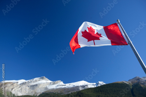 canadian flag with mountain backdrop