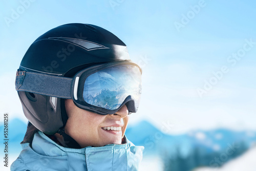 Close Up Of The Ski Goggles Of A Man With The Reflection Of Snowed Mountains.  A Mountain Range Reflected In The Ski Mask.  Portrait Of Man At The Ski Resort On The Background Of Mountains And Sky