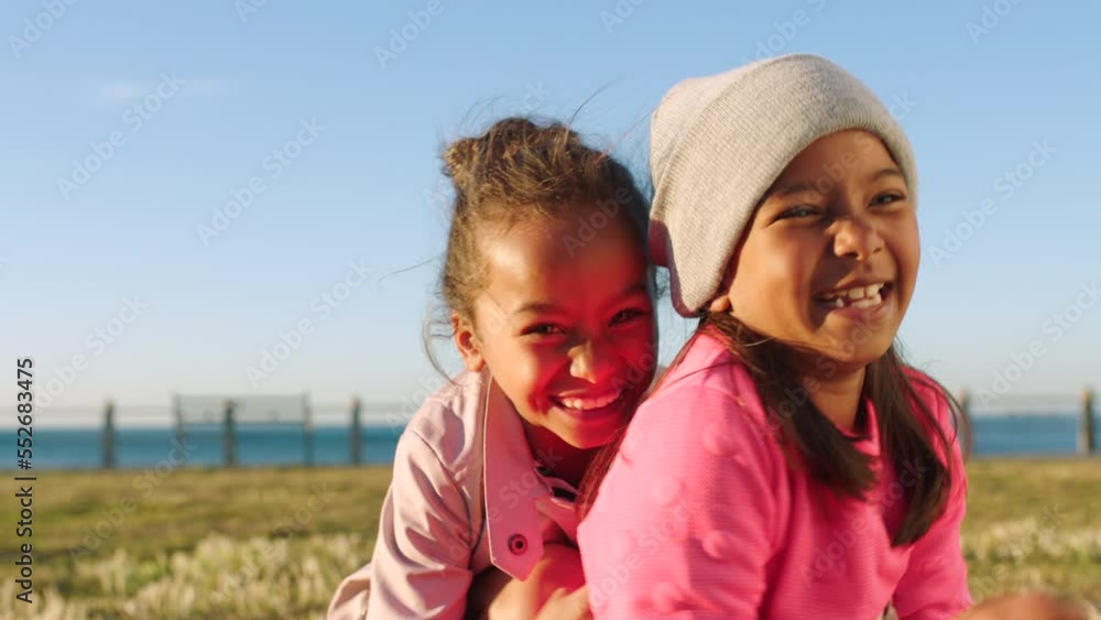 Friends, grass and portrait of girl children at beach having fun and playing in a park. Nature, freedom and sisters with smile, kids play and hug outside together on happy summer holiday at the ocean Friends, grass and portrait of girl children at beach having fun and playing in a park. Nature, freedom and sisters with smile, kids play and hug outside together on happy summer holiday at the ocean