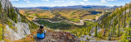 Woman hiking along the Dempster Highway enjoying the scenery on top of Sapper Hill; Yukon, Canada photo