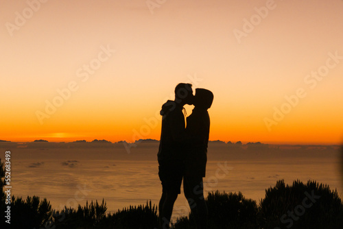 silhouette of a couple kissing at the sunrise