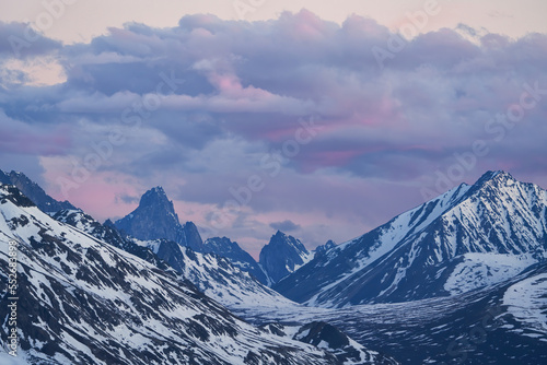 Pastel hues of the sunset over Tombstone Mountain and the Ogilvie Mountain Range along the Dempster Highway near Dawson City; Yukon, Canada photo