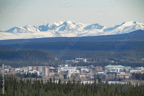 Downtown Whitehorse with snow-covered mountains in the distance; Whitehorse,Yukon, Canada photo