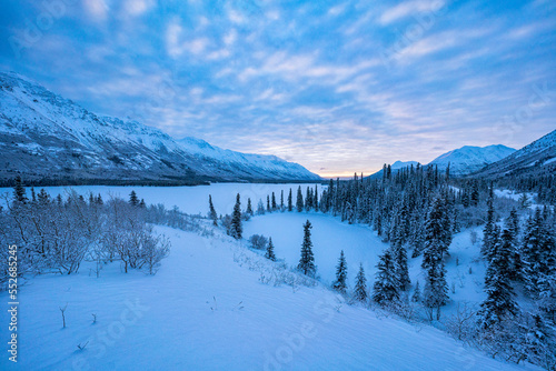 Stunning snowy landscape with sunrise over Annie Lake in Winter; Whitehorse, Yukon, Canada