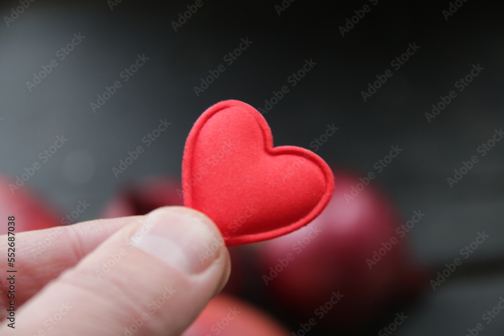 Hand holding a heart on the background of an apple healthy food concept. Hand holding a heart on the background of an apple healthy food concept.
