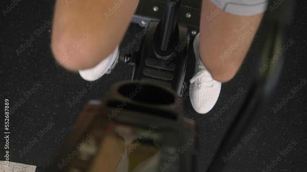 Male athlete training on exercise bike cardio endurance workout at the gym Male athlete training on exercise bike cardio endurance workout at the gym