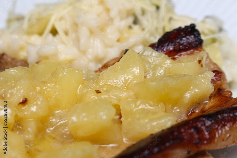 pork served with pineapple and zucchini risotto. gourmet meal with meat, fruit, rice and cheese. pork with pineapple. pork served with pineapple and zucchini risotto. gourmet meal with meat, fruit, rice and cheese. pork with pineapple.