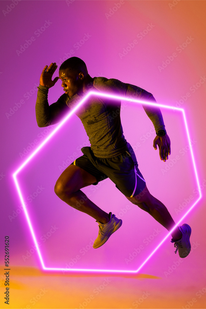 Illuminated hexagon over confident african american male athlete running on gradient background Illuminated hexagon over confident african american male athlete running on gradient background