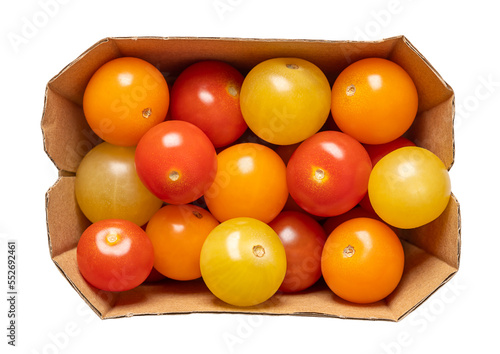 Colorful cherry tomatoes  in a cardboard punnet. Fresh and ripe type of small and round cocktail tomatoes  of red  yellow and orange color. Solanum lycopersicum var. cerasiforme. Isolated  from above.