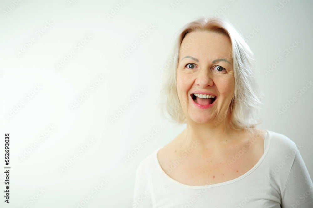 Cheerful happy adult beautiful girl looking at camera smiling laughing over white background Beautiful candid woman with short hair and without makeup smiling, standing in t-shirt Cheerful happy adult beautiful girl looking at camera smiling laughing over white background Beautiful candid woman with short hair and without makeup smiling, standing in t-shirt