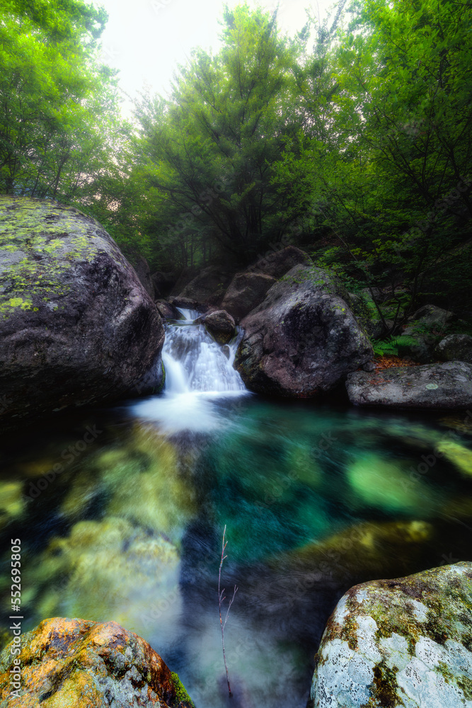 Long exposure of a little waterfall inside a stream in the Valsangone valley, Piedmont, Italy Long exposure of a little waterfall inside a stream in the Valsangone valley, Piedmont, Italy