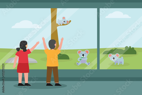 children looking at koala in the zoo while standing near the fence