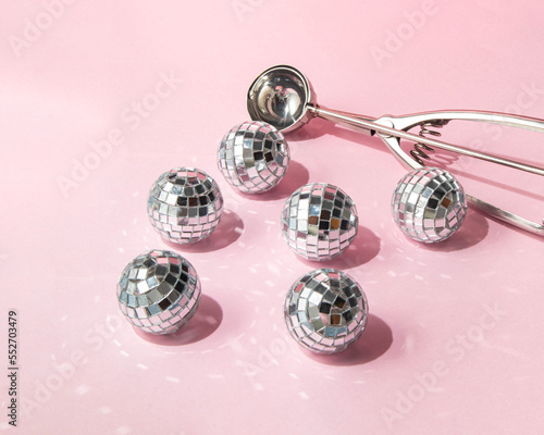 Christmas baubles as ice cream balls on pastel light pink background. Minimalistic New Year concept. Christmas flat lay. Creative Xmas composition.