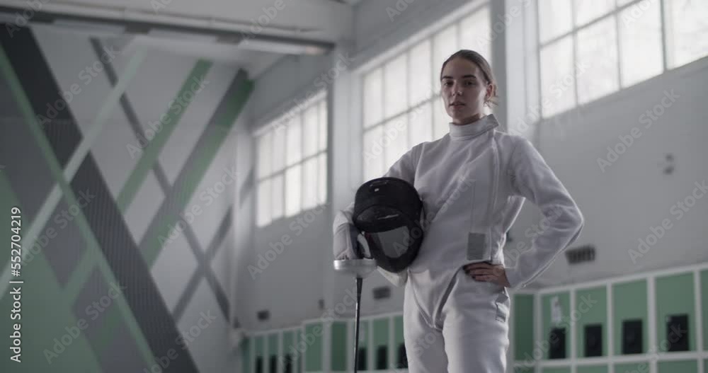 Confident female fencer in gym Confident female fencer in gym