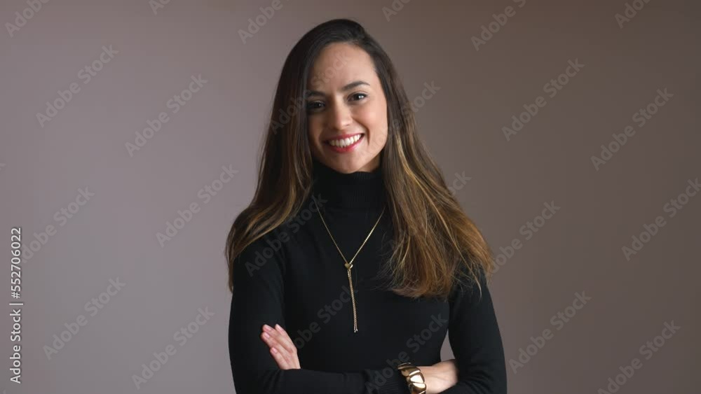 A medium shot of young brunette smiling woman standing with arms croseed. High quality 4k footage A medium shot of young brunette smiling woman standing with arms croseed. High quality 4k footage