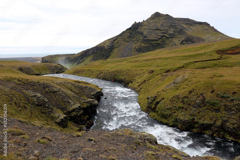 A view looking down the Skóga River with the mist of Skógafoss in the distance. Located in southwestern Iceland. A view looking down the Skóga River with the mist of Skógafoss in the distance. Located in southwestern Iceland.