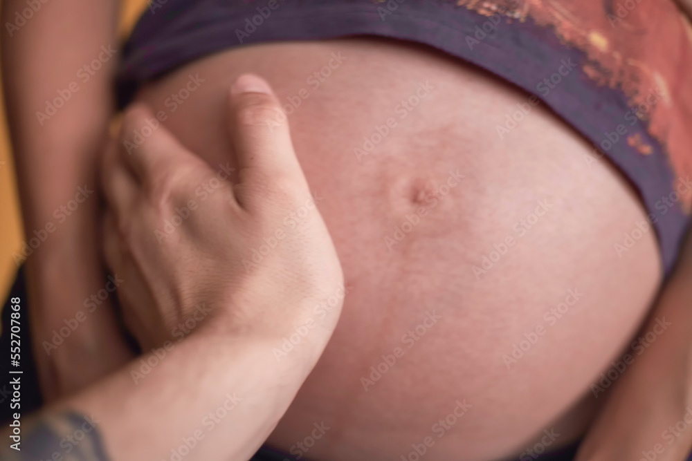 hand on a pregnant woman belly hand on a pregnant woman belly