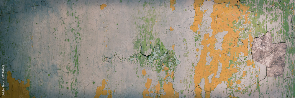 Peeling paint on the wall. Panorama of a concrete wall with old cracked flaking paint. Weathered rough painted surface with patterns of cracks and peeling. Wide panoramic grungy texture for background