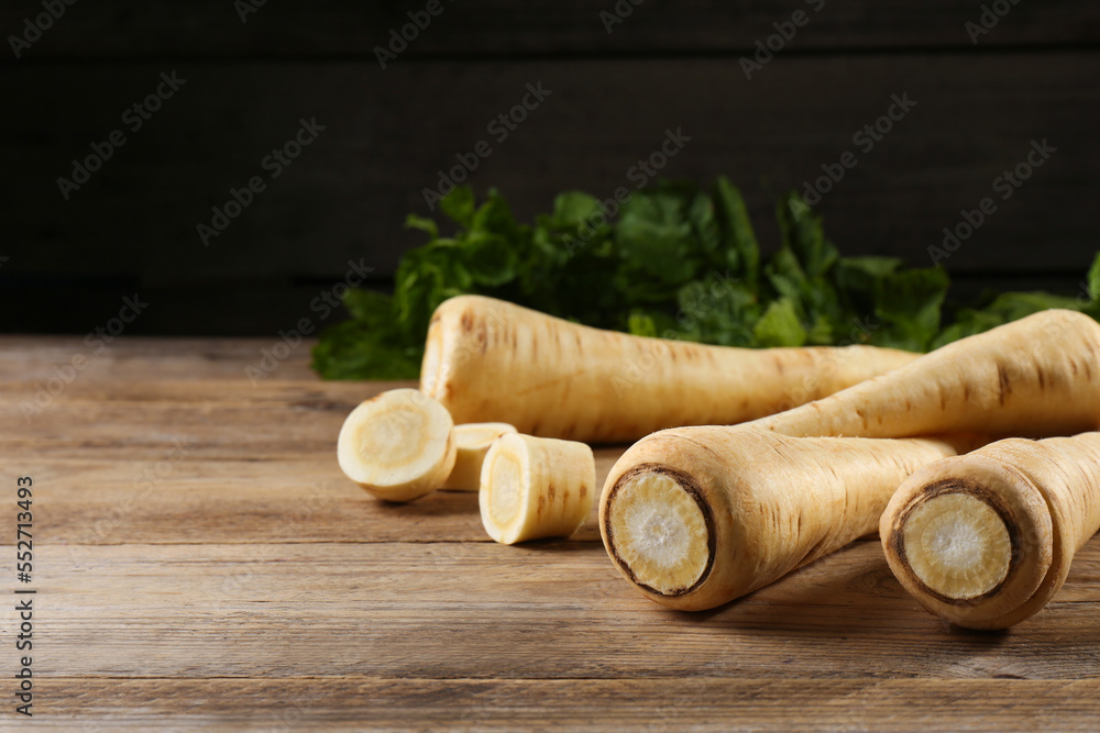 Fresh ripe parsnips on wooden table, closeup. Space for text Fresh ripe parsnips on wooden table, closeup. Space for text