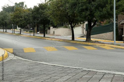 Photography City street with striped concrete speed bump