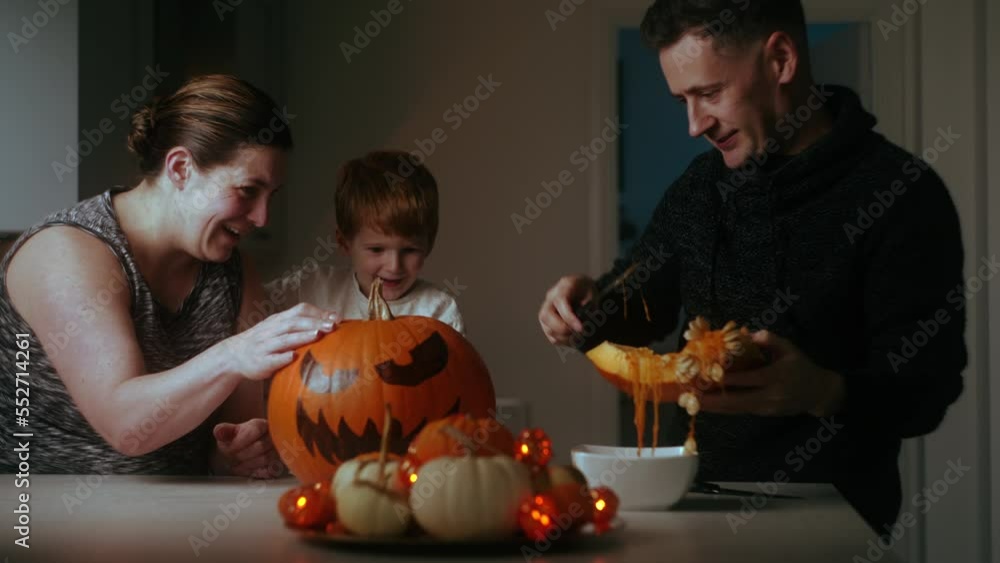 Happy family prepare pumpkin to celebrate Halloween. carve the pumpkin. Happy family prepare pumpkin to celebrate Halloween. carve the pumpkin.