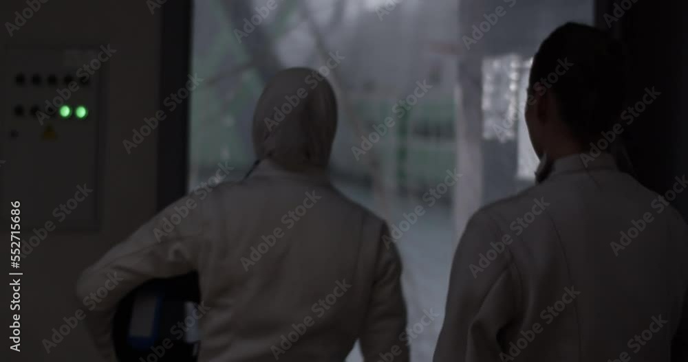 Anonymous diverse fencers entering gym Anonymous diverse fencers entering gym