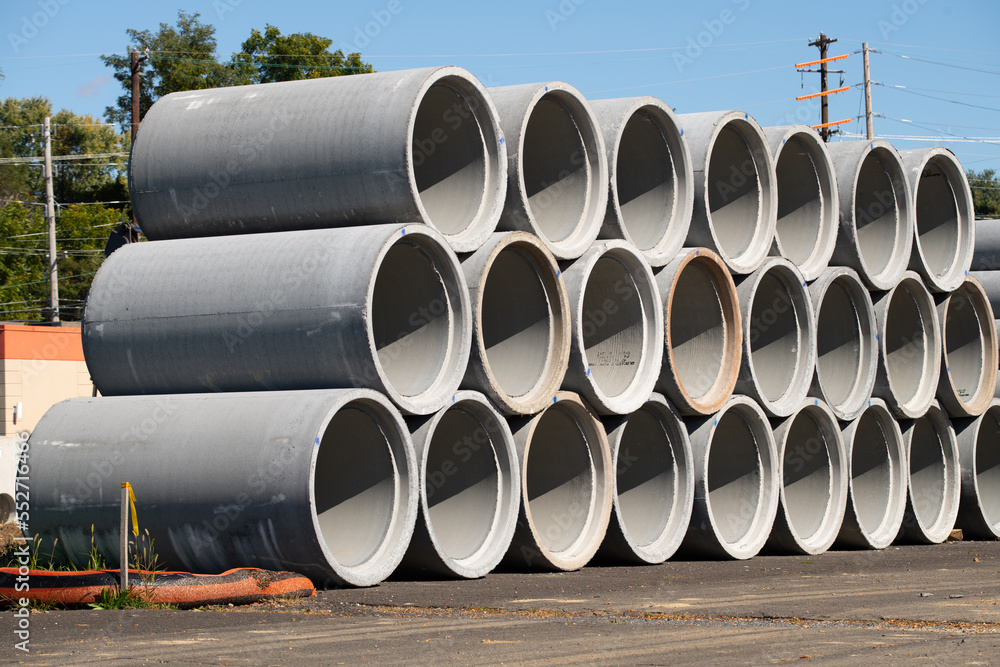 Concrete round big pipes stacked outdoors Concrete round big pipes stacked outdoors