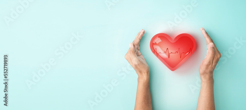 Hand hold 3d transparent heart shape with cardiogram, heart disease awareness campaign, cardiovascular health, Stroke Prevention, hypertension (high blood pressure) for heart disease concept