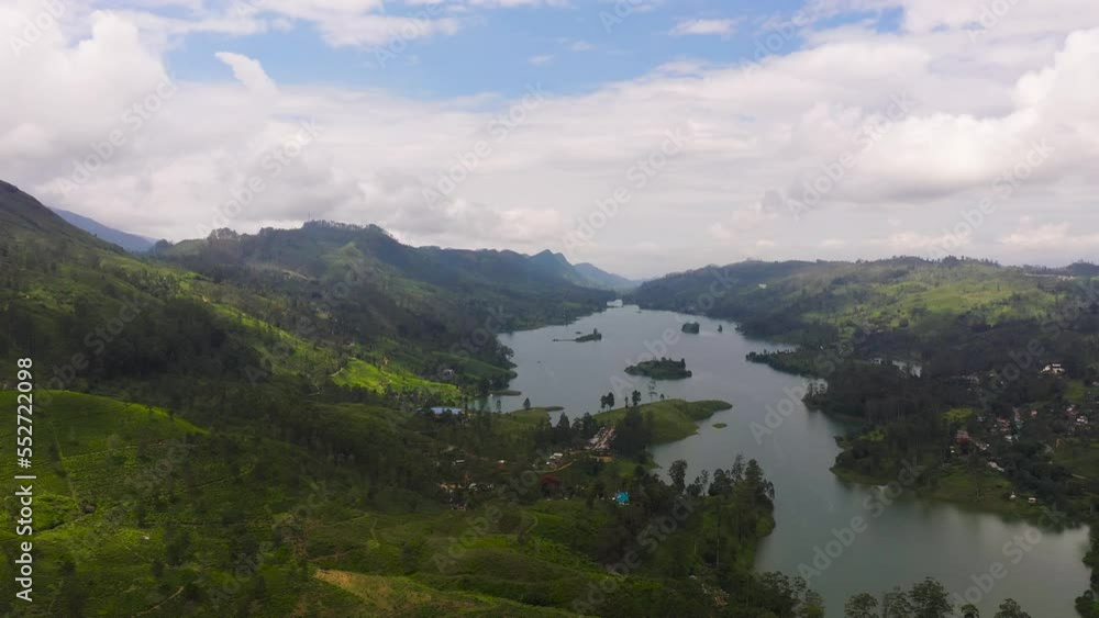 Aerial view of lake in the mountains surrounded by hills with tea plantations. Maskeliya, Castlereigh, Sri Lanka. Aerial view of lake in the mountains surrounded by hills with tea plantations. Maskeliya, Castlereigh, Sri Lanka.