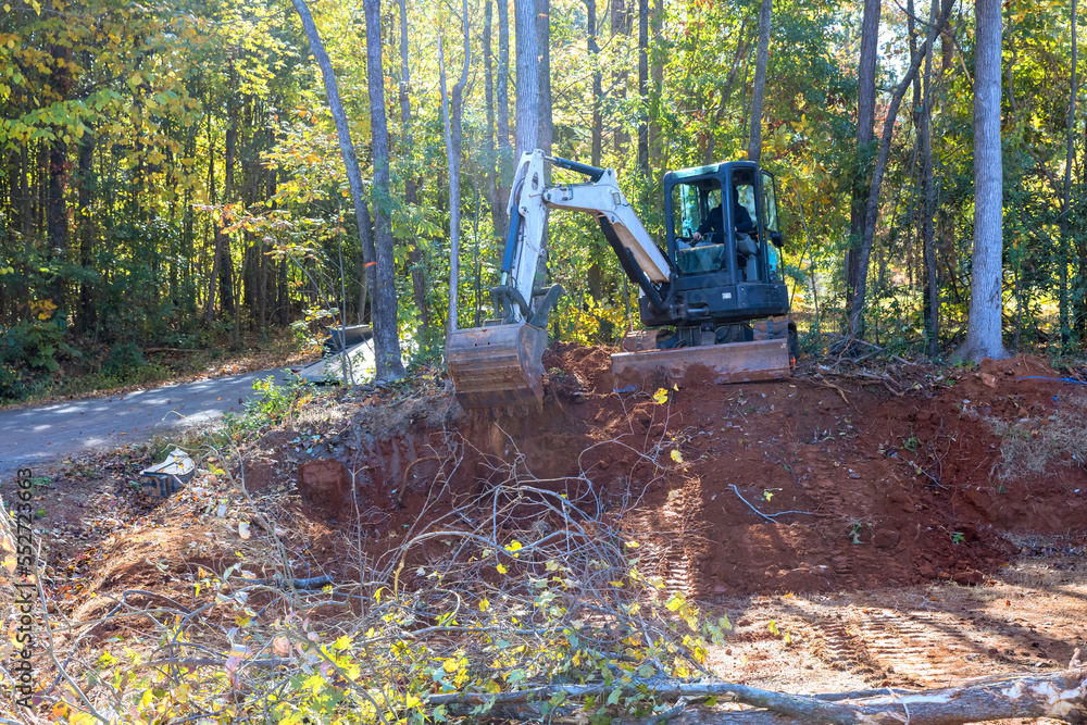 Uprooting trees and preparing land for construction is done with tractor Uprooting trees and preparing land for construction is done with tractor