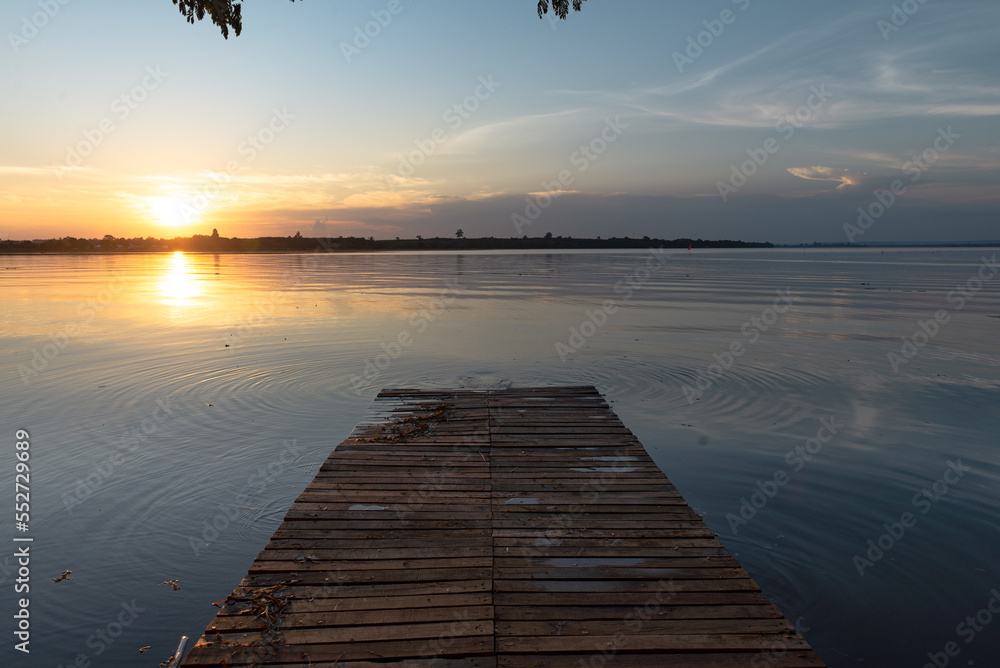 Wooden pier at sunset on a lake in Bueng Kan, Thailand 2022 