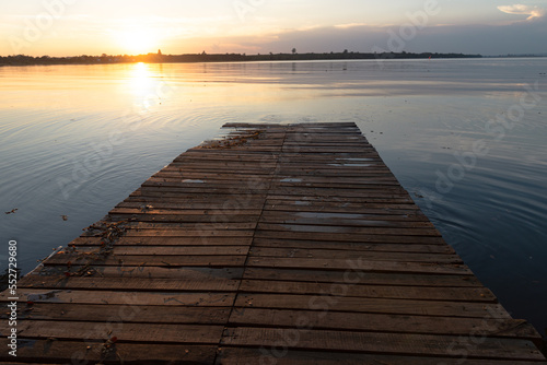 Wooden pier at sunset on a lake in Bueng Kan, Thailand 2022 