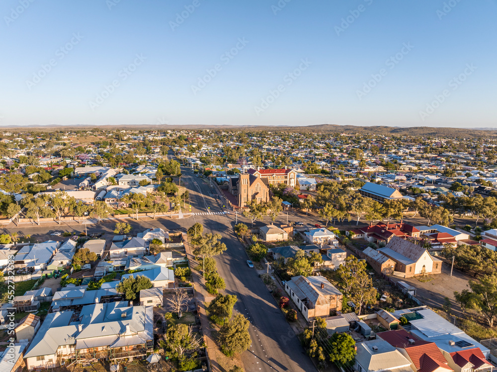 Early morning sunrise high angle aerial drone view of the Cathedral of the Sacred Heart of Jesus, a catholic church, and the historic outback mining town of Broken Hill, New South Wales, Australia.