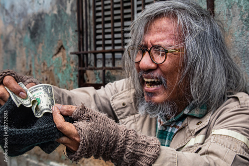 Картината върху платно Asian homeless man feel happy and crying  receives money from a passerby to help