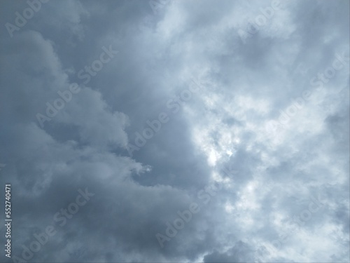 Grey sky, cloudy background, changeable weather natural clouds. Overcast but beautiful, dramatic sky effect. View of overcast sky. Dramatic gray sky and white clouds before rain in rainy season. © Chatchaa