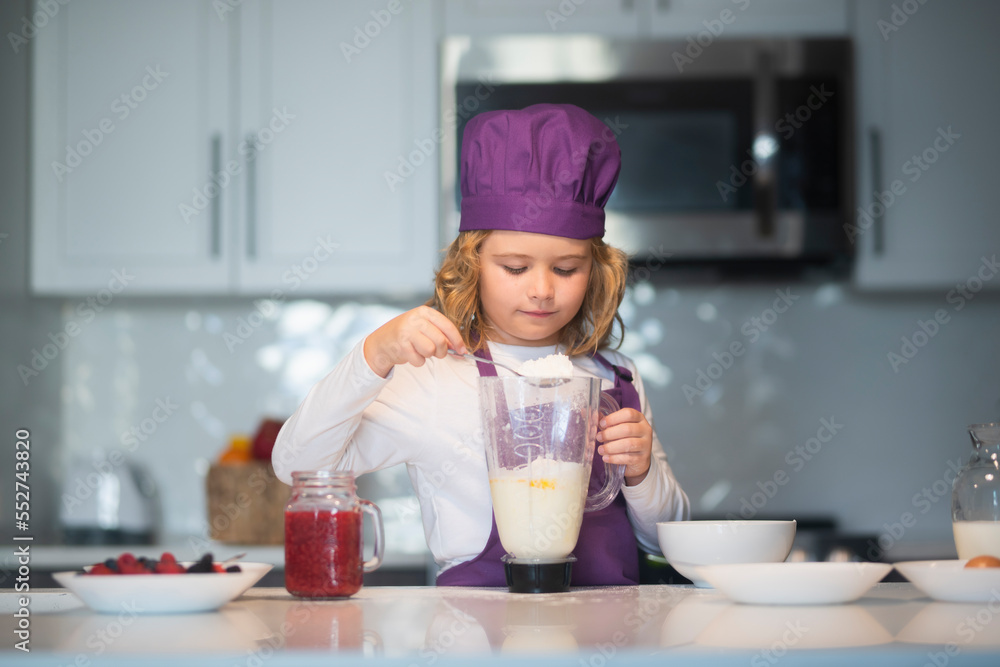 Kid in chef hat and apron. Child making tasty delicious. little boy in chef hat and an apron cooking in the kitchen. Kid in chef hat and apron. Child making tasty delicious. little boy in chef hat and an apron cooking in the kitchen.