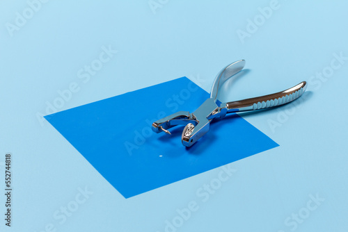 Dental hole punch on a rubber dam.