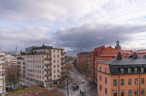 View from the cliff Kungsklippan, down town apartment houses and offices a winter day with dark clouds and low sun in Stockholm