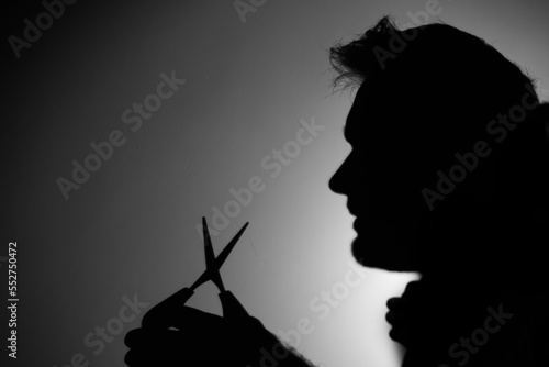 shadow of a man with scissors
