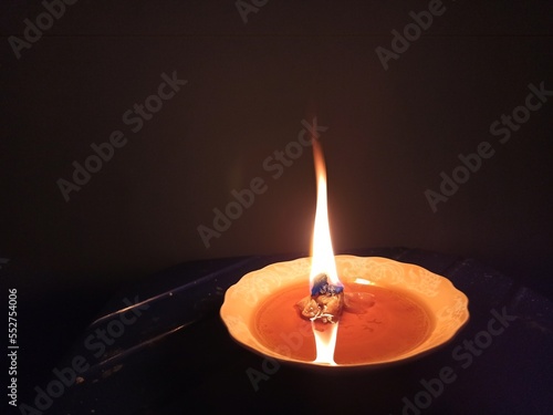 burning candle in the dark. Black background.