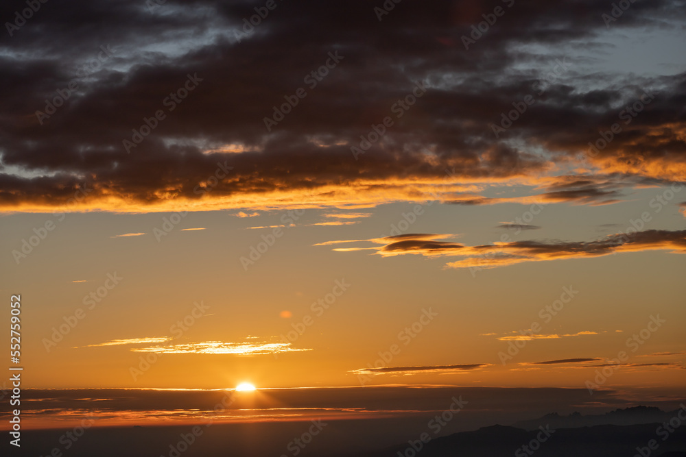 sunset at the top of the mountain with views of the clouds and the forest with a spectacular colors of sunlight
