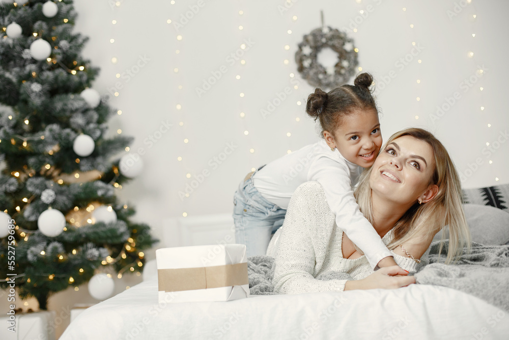 Caucasian mother with little african daughter at home Caucasian mother with little african daughter at home