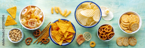 Salty snacks panorama. Party food. Potato and tortilla chips, crackers