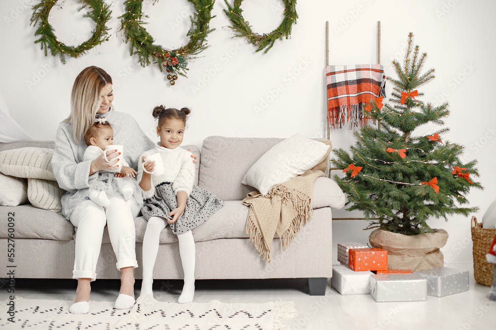 Caucasian mother with two little african daughters at home Caucasian mother with two little african daughters at home