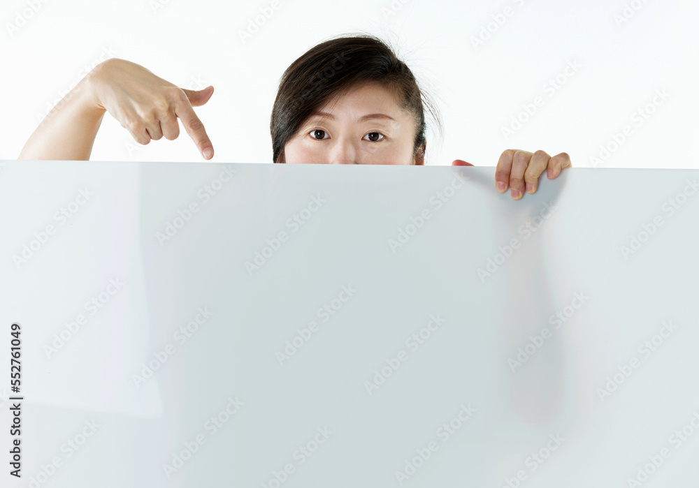 Young asian woman showing blank board isolated on white background Young asian woman showing blank board isolated on white background